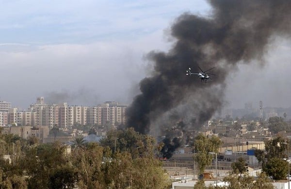 A Blackwater Security Company MD-530F helicopter aids in securing the site of a car bomb explosion in Baghdad, Iraq, on December 4, 2004, during Operation IRAQI FREEDOM.(U.S. Air Force Photo by Master Sgt. Michael E. Best) (Released) (Released to Public)