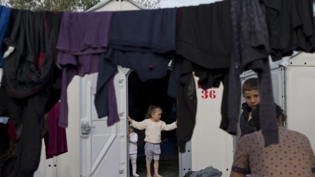 Children wait at a refugee camp on the island of Lesbos, Greece. Migrant arrivals in Greece have waned, though many are now held in Turkey after an EU agreement in March intended to control flow of migrants to the continent. Photo: AP via bbc.com