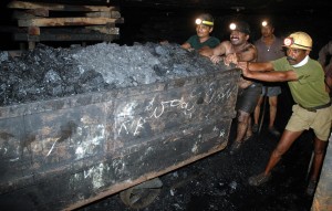 Indian coal miners push a trolley laden with coal inside an underground tunnel of a mine at Godavarikhani, July 27, 2007. (NOAH SEELAM/AFP/Getty Images)