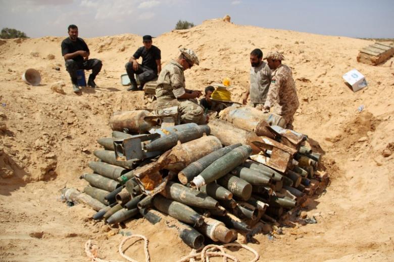 Libyan militia watch over explosives and shells left behind by Islamic State soldiers in the battle over the city of Surt, Libya on Sept. 9, 2016. Photo: REUTERS/Stringer
