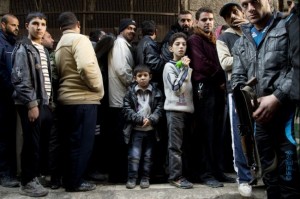 syria_boy_stands_in_bread_line_1209