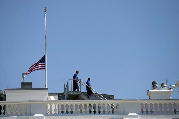 The American flag at half mast on the roof of the White House. Source: AP