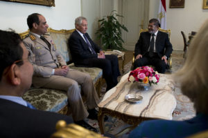 Morsi Attends Trial in a Glass Cage of Silence