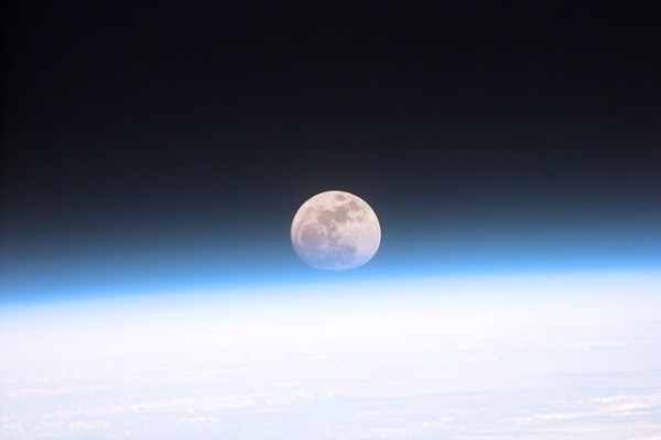 Astronauts aboard the Space Shuttle Discovery recorded this rarely seen phenomenon of the full Moon partially obscured by the atmosphere of Earth. Photo Credit: NASA