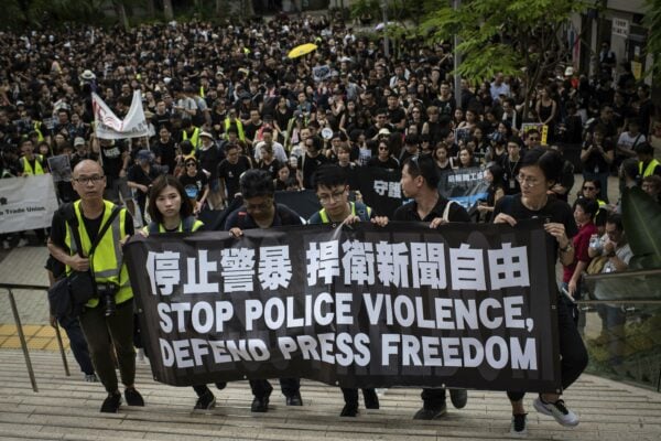 Protesters hold a banner during a march, organized by media groups and journalist trade unions, calling for press freedom amidst the ongoing protests in Hong Kong. In addition to political pressure, journalists have increasingly been the targets of physical and verbal assaults from police Ivan Abreu / SOPA Images/Sipa USA via The Associated Press