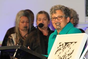 Erana Ta Haeata Brewerton accepting a lifetime achievement award on behalf of her late mother, Dame Kāterina Te Heikōkō Mataira. (file photo, Massey University)