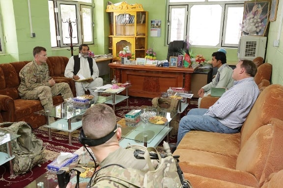 A Public Affairs Officer for PRT Farah, and his USAID colleague, talk with Lal Mohammed Bahari, Farah Provincial Director of Information and Culture, Farah City, Afghanistan, April 2013 (U.S. Navy photo by HMC Josh Ives/released)