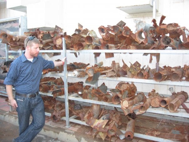 Noam Bedein with a display of qassam rockets that have been fired at Israel since 2005