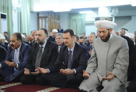 Syria's President Bashar al-Assad (2nd R) attends Eid al-Fitr prayers at Anas bin Malek mosque in Damascus August 8, 2013, in this handout photograph released by Syria 's national news agency SANA. Syrian rebels said on Thursday they targeted al-Assad's motorcade heading to a Damascus mosque to mark the Muslim holiday of Eid al-Fitr, but state television showed him unharmed and the government denied he had been attacked.  REUTERS/SANA/Handout via Reuters