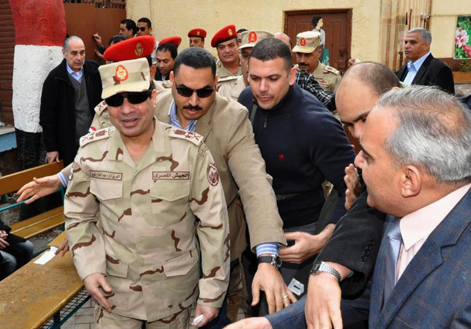 Abdel Fattah al-Sisi, Egypt's military leader (in uniform, foreground), is seen at a polling station in Jan. 2014 for Egypt's vote on constitutional reform. As democratic advances in Egypt (and Turkey) dissipate, Egyptians have come to support reinstating the very same elements they violently ousted in 2011.  Photo: (AP Photo/Egyptian Defense Ministry via Facebook, File) 