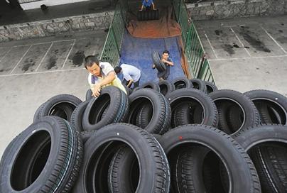 Chinese workers load tires for export.  Source:  www.financialpost.com