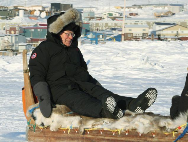 Governor of the Bank of England Mervyn King riding a dogsled in Iqaluit. © AP