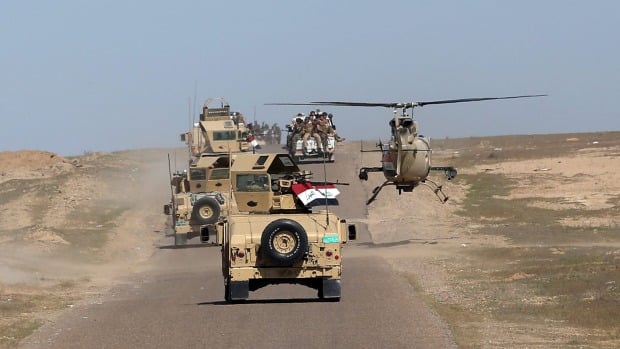 Iraqi Defence Minister Khaled al-Obeidi's convoy tours the front line in the Samarra desert, Iraq, earlier this month. (Associated Press)