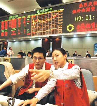 Traders discuss oil futures on the Shanghai Futures Exchange.