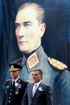 Turkish President Abdullah Gul (r.) stands by a military officer in front of an image of Mustafa Kemal Ataturk - Photo Credit: Newscom