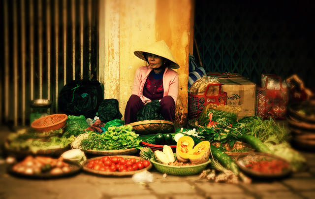 Vendor at a street market in Vietnam, courtesy Chris Goldberg/Flickr (CC BY-NC 2.0)